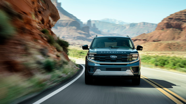 A Ford Expedition cruises through mountains.