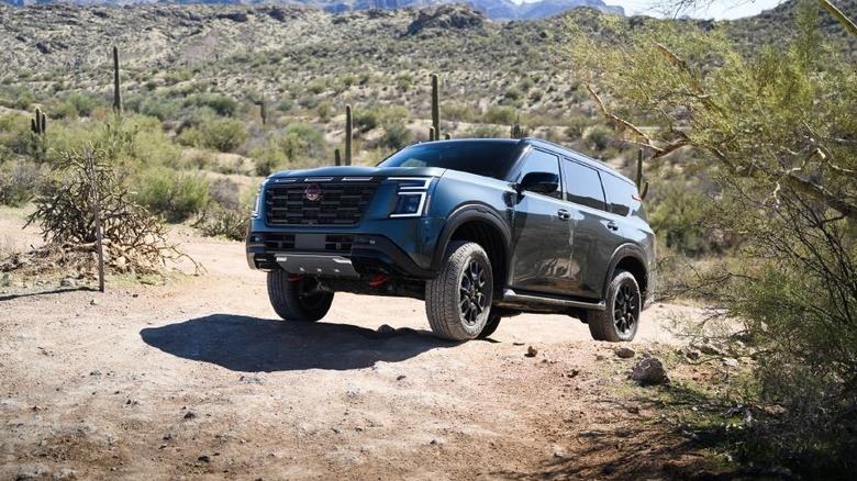 A Nissan Armada climbs up a steep trail.