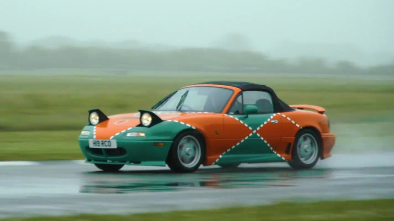 A Mazda MX-5 Le Mans Edition driving on a wet track