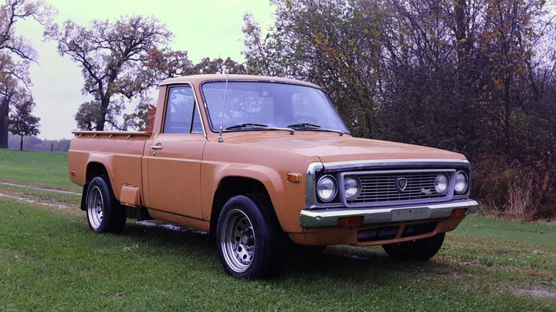 A brown Mazda REPU pickup truck on grass