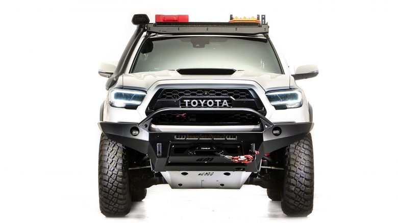 A frontal image of a Toyota Tacoma with LED headlights on a white background.