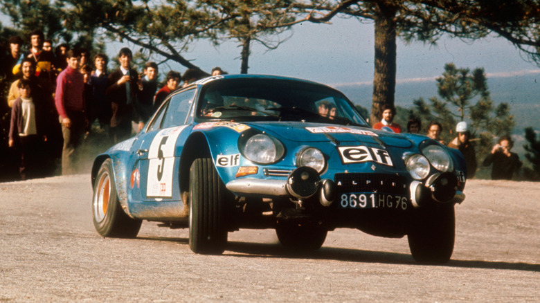 Original Alpine A110 drifting around a corner during rally racing