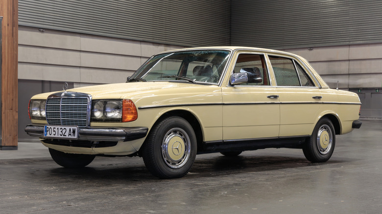 A Mercedes-Benz 300D sits parked.