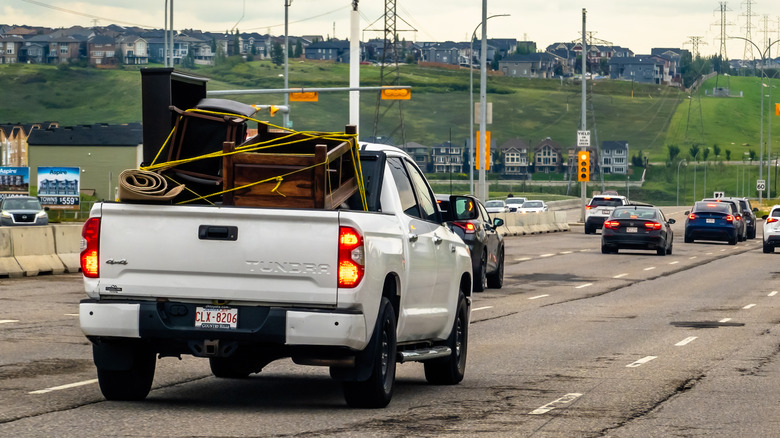 A white Toyota Tundra hauls stuff.