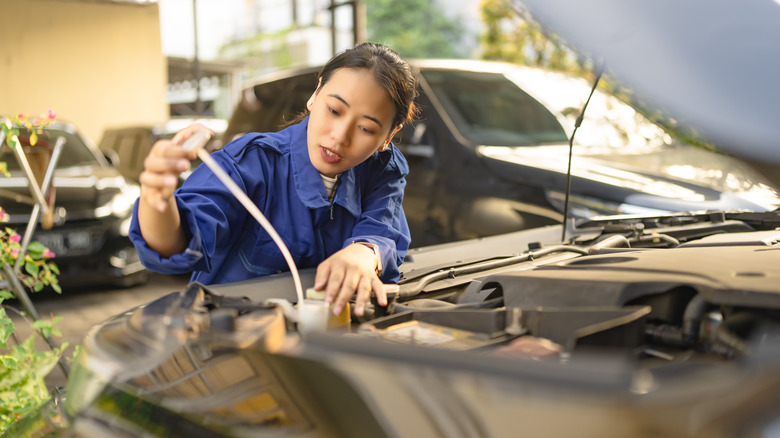 Woman checking a car's fluids