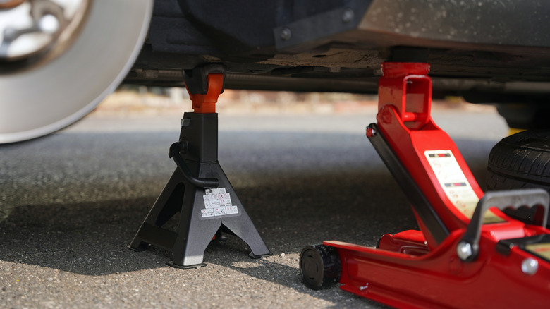 Jack and jack stands underneath car.