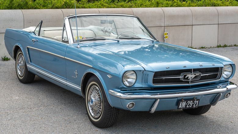 A ray bluish convertible Ford Mustang from nan 1960s parked extracurricular pinch nan apical down.
