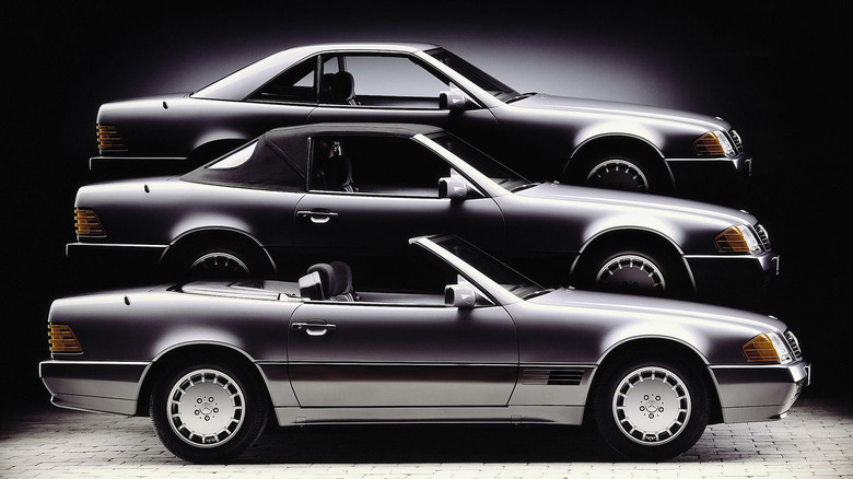A dramatic, vertically stacked studio composition featuring three identical silver Mercedes-Benz SL (R129) sports cars against a dark background, demonstrating the model's three roof configurations.