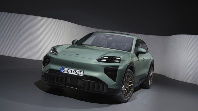 Sage green Porsche Cayenne Turbo Electric shot in a studio.