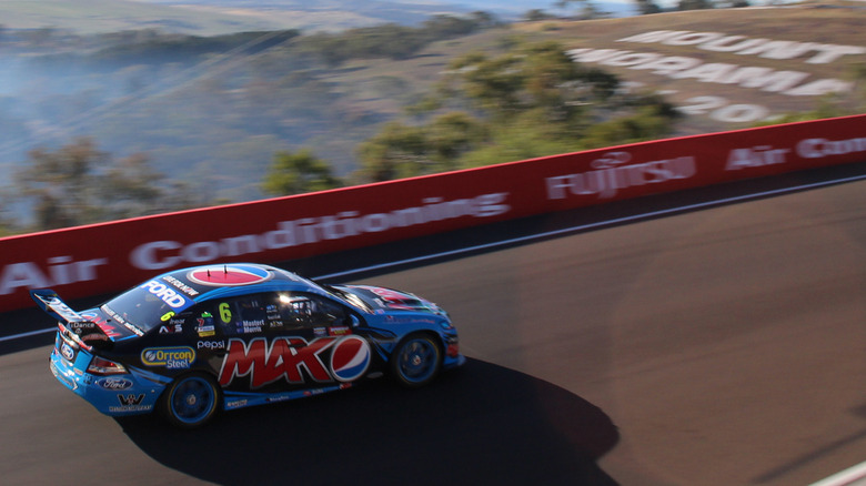 Chaz Mostert's Ford GT Flacon in race livery seen from left rear on a high curve during the 2014 Bathurst 1000 race
