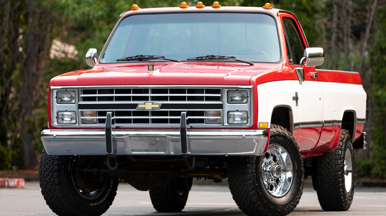 Chevy C/K pickup truck driving down the street