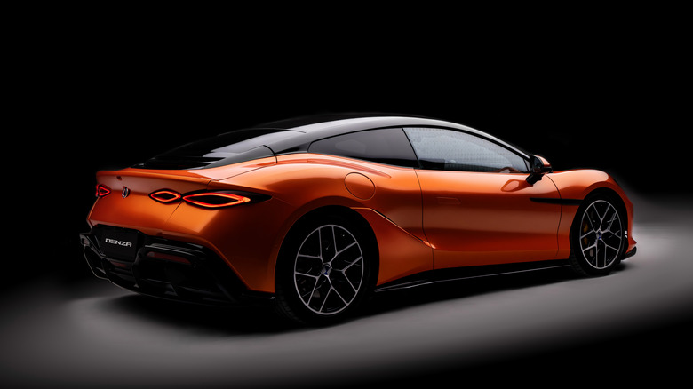 Rear 3/4 view of an orange Denza Z