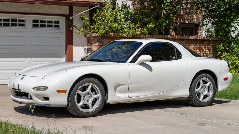 A third-generation Mazda RX-7 in white, shown from side.