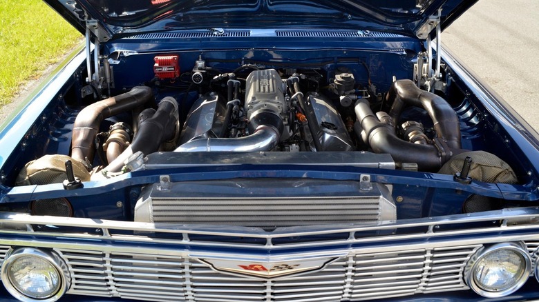 A modified 1961 Chevrolet Impala Bubbletop displays its twin-turbocharged big block V8 engine