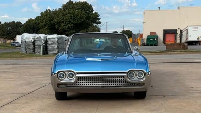 A blue 1961 Ford Thunderbird shows off its front end with aftermarket LED lights