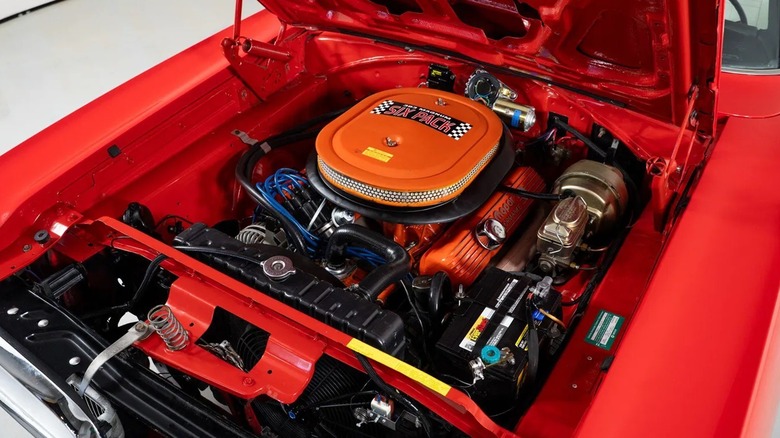 An overhead shot of a 1970 Dodge Super Bee and its open engine bay