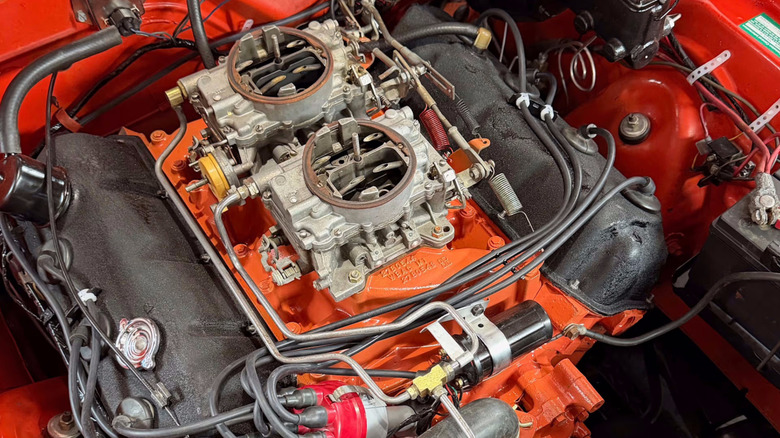 Exposed dual carburetors atop the 426-cubic-inch 450-horsepower V-8 motor in the engine bay of the 1970 Plymouth Hemi 'Cuda up for auction at Mecum on November 14, 2026.