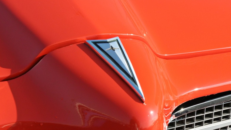 A Pontiac badge on a red '70s Pontiac