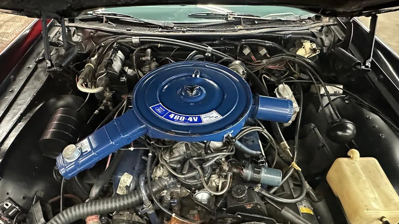 The engine bay of a 1977 Lincoln Continental shows a blue-painted big-block v8 engine.