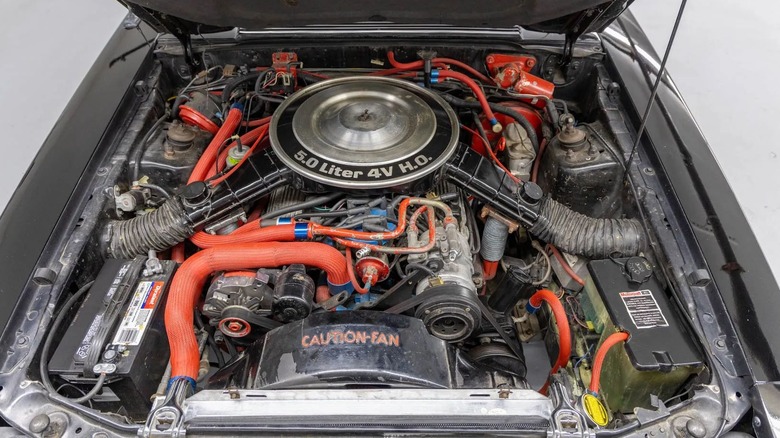A look under the hood of the black Fox Body showing its 5.0-liter V8