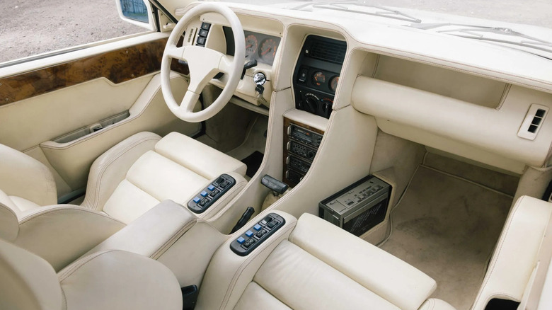 A look at the white leather dashboard, steering wheel, and front seats in the Sbarro Super Five