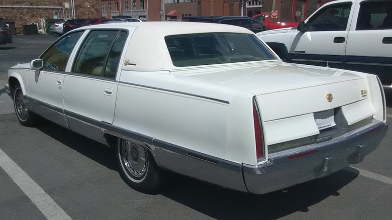 A white 1993-1996 Cadillac Fleetwood Brougham in parking lot
