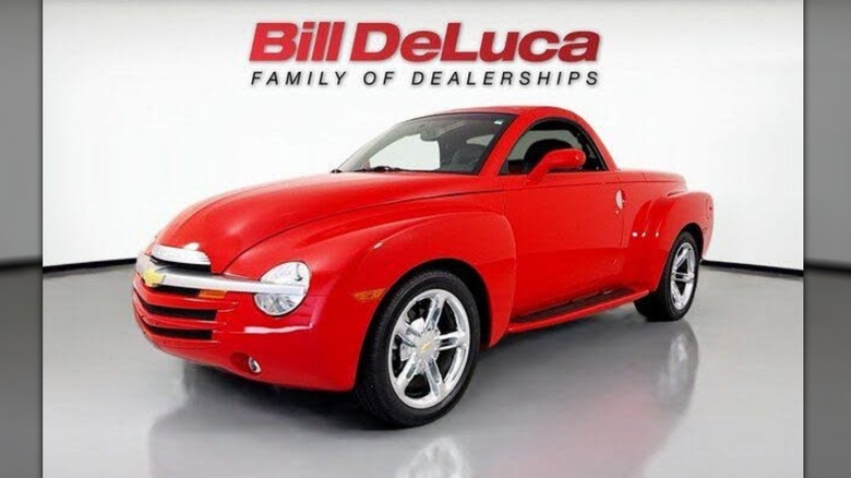 A red Chevy SSR sits parked in a dealership.