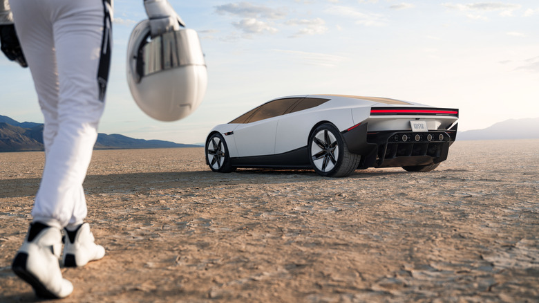 A person in a space suit approaches the Roadster