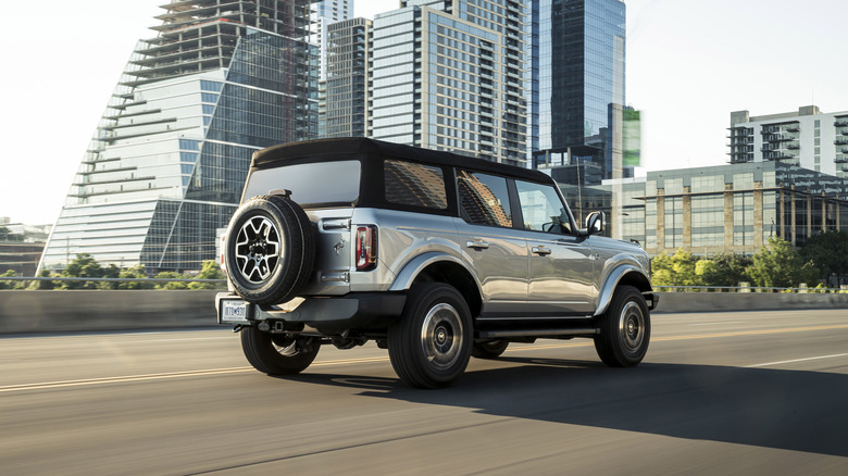 A silver 2021 Ford Bronco on a roadway.