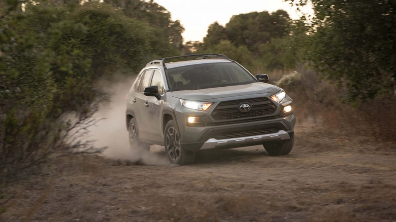 A 2021 Toyota RAV4 driving enthusiastically over a dirt road