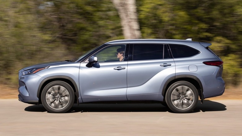 Left side view of a 2021 Toyota Highlander AWD variant moving over the tarmac