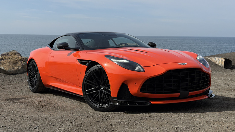 Front 3/4 view of an orange Aston Martin DB12 S coupe