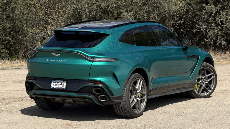 Rear 3/4 view of a green 2026 Aston Martin DBX S
