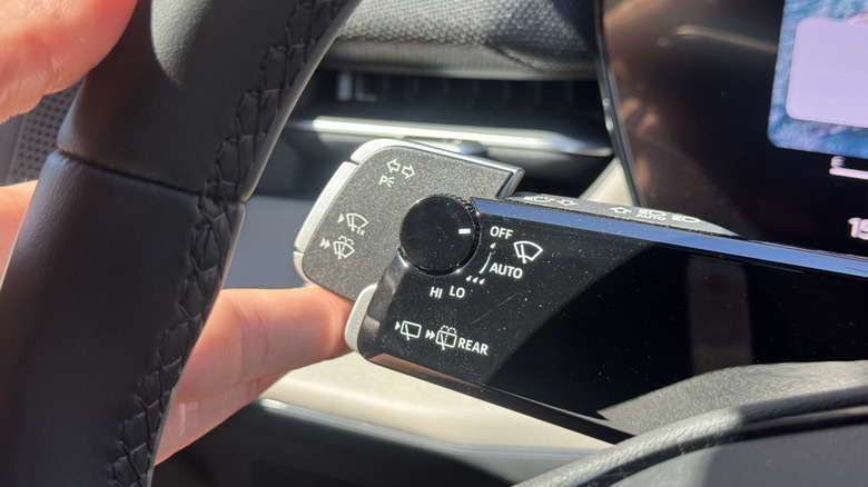 A close-up shot of the new turn signal mechanism on the Q3, with my finger pushing it up to activate the right turn signal