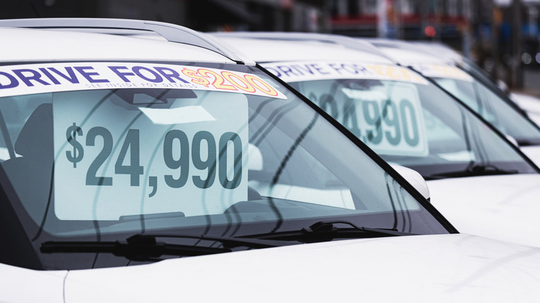 Used cars for sale showing prices in windshields