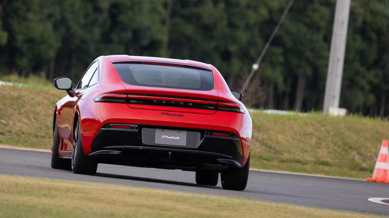 Rear view of a red 2026 Honda Prelude driving on track