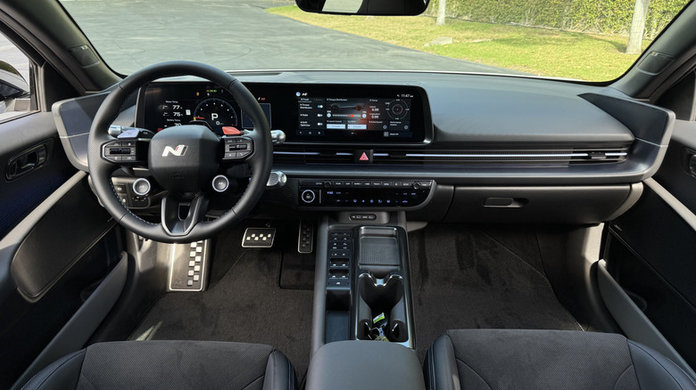 A look at the dashboard in the new Ioniq 6 N showing the black interior and grass outside the windshield