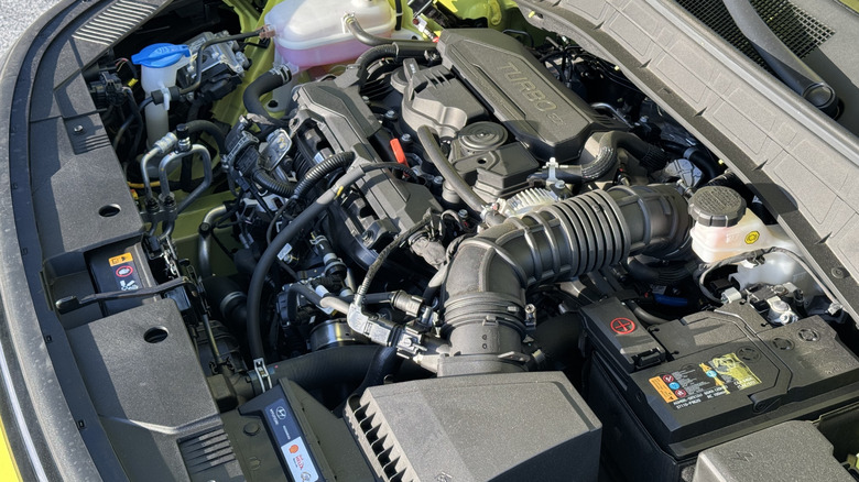 A wide under-hood shot of the Kona's turbocharged 1.6-liter four-cylinder engine