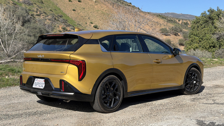 Rear 3/4 view of a yellow 2026 Kia K4 Hatchback