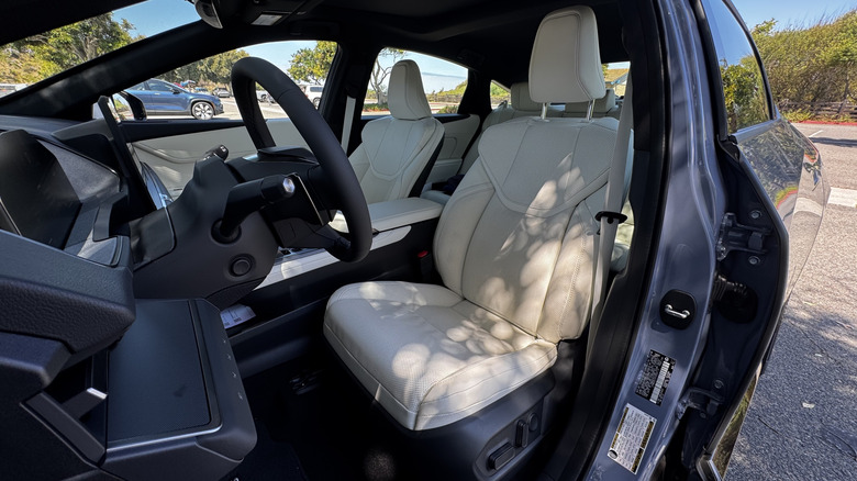 A look in the driver's door back at the driver's seat of the ES with a white interior