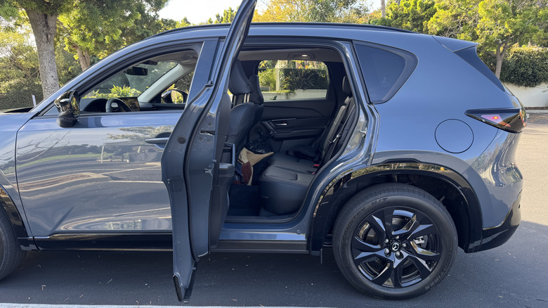 A look at how wide the rear doors open, showing the side of the gray CX-5 with the rear door open looking into the interior