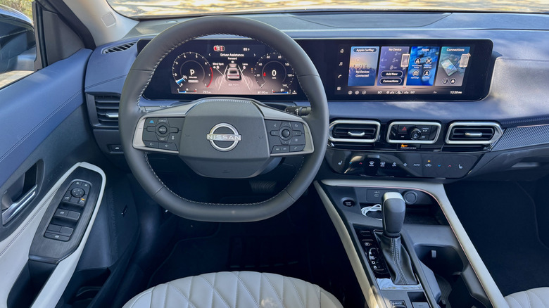 A look astatine nan driver's POV successful nan Sentra SL showing nan quilted achromatic seats, dual 12.3-inch displays, and contrasting bluish dashboard
