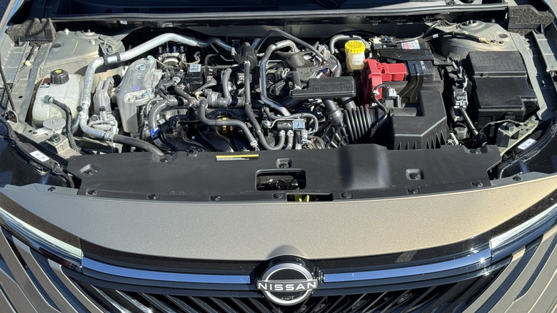 An underhood changeable of nan tan Sentra SL showing nan motor and beforehand Nissan badge