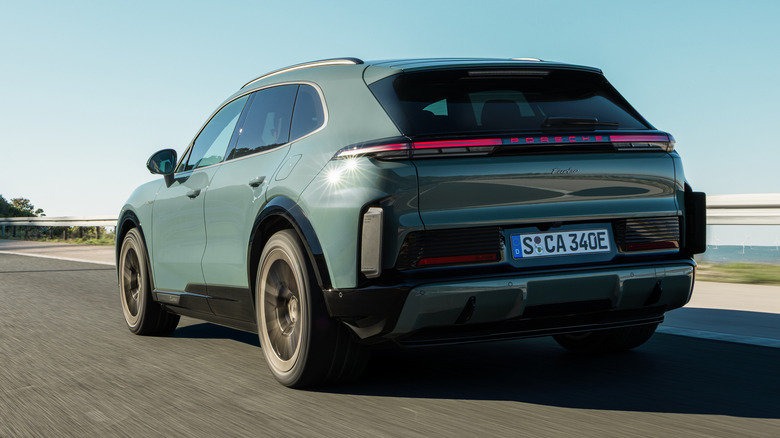 Rear 3/4 view of a green 2026 Porsche Cayenne Turbo Electric