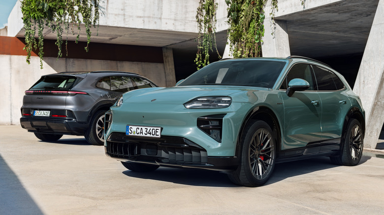 A green Porsche Cayenne Electric next to a grey one