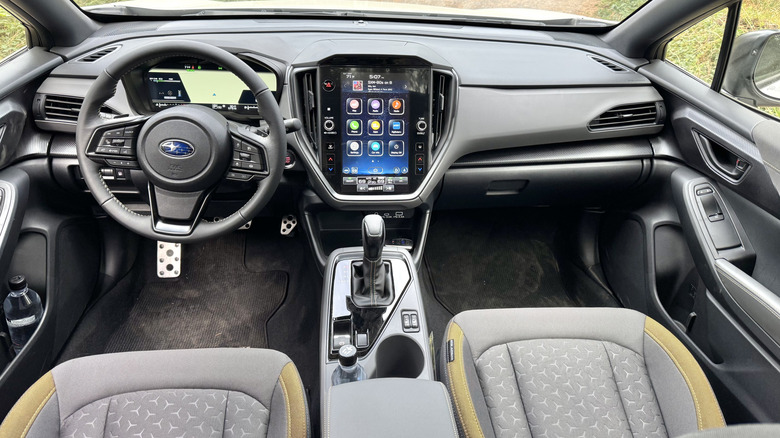 A look at the Crosstrek Hybrid's dashboard showing its screens and cloth seats