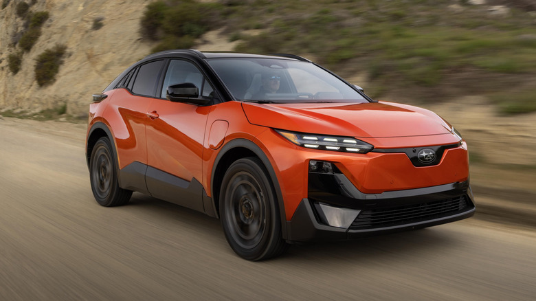 Front 3/4 view of an orange 2026 Subaru Uncharted driving