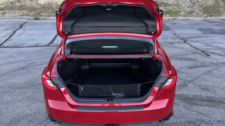 A rear shot of the red Camry Nightshade parked on asphalt with its trunk open