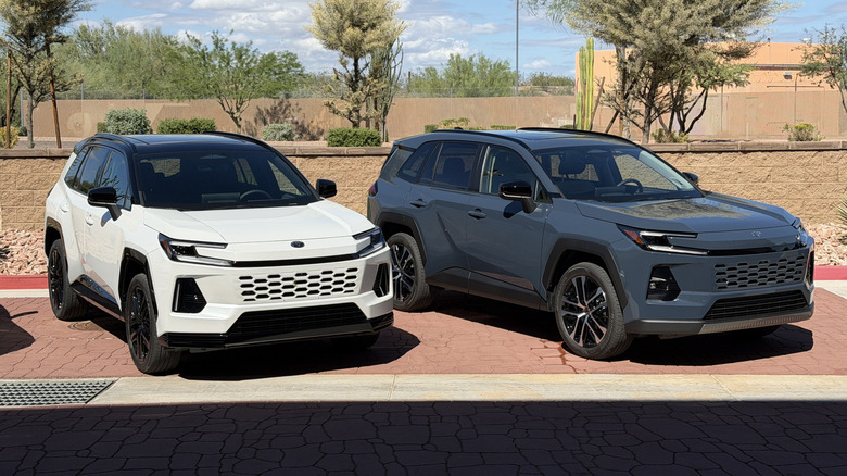 A white 2026 Toyota RAV4 next to a gray 2026 Toyota RAV4