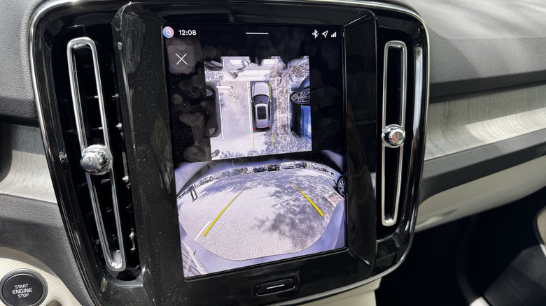 A close-up of the center screen with the reverse camera and the overhead camera feed